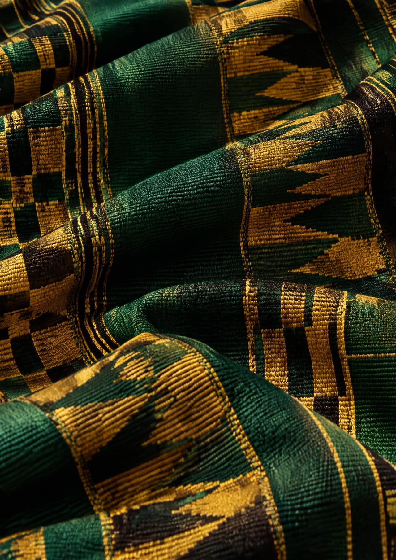 Detail of hand-woven Kente cloth in gold, green and black